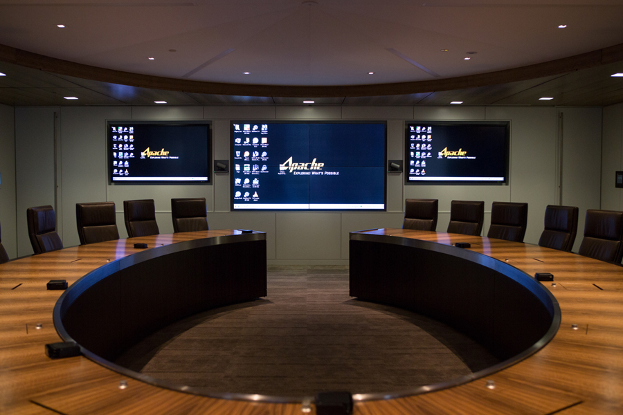 a conference room with a large screen that says apache