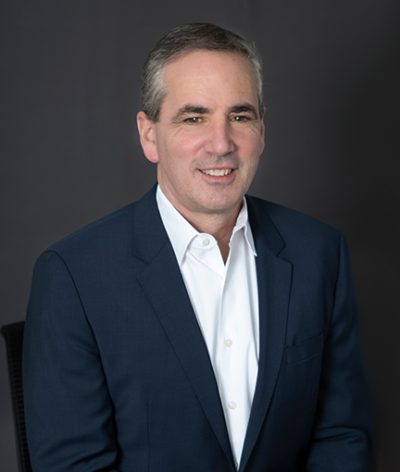 David Katz in a suit and white shirt smiling for a professional photograph