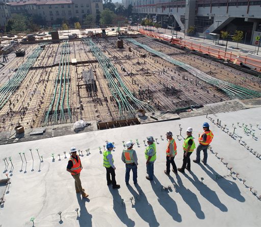 a group of construction workers are standing on a construction site