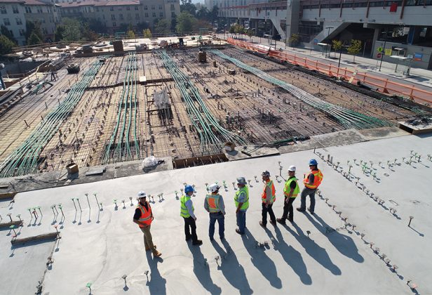 a group of construction workers are standing on a construction site