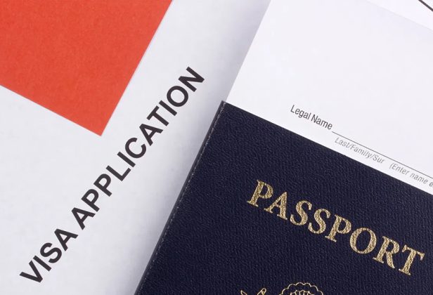 a passport sits next to a visa application