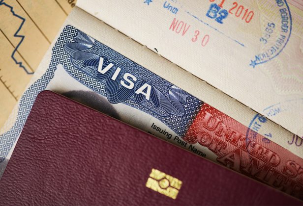 a close up of a visa on top of a passport