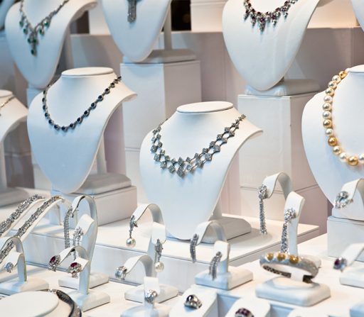 a display of luxury necklaces and bracelets on mannequins