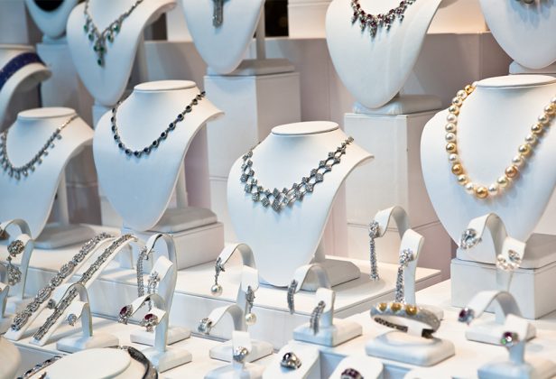 a display of luxury necklaces and bracelets on mannequins