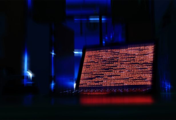 a computer screen with a lot of lines of code on it in a dark room