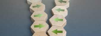 a row of wooden blocks with green arrows pointing in opposite directions