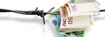 a bunch of 50 euro bills are tied to barbed wire