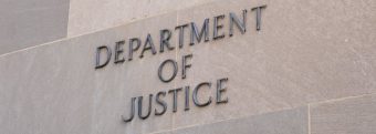 a sign for the department of justice is on the side of a building