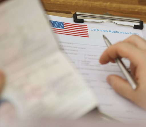 a person is filling out a usa visa application form