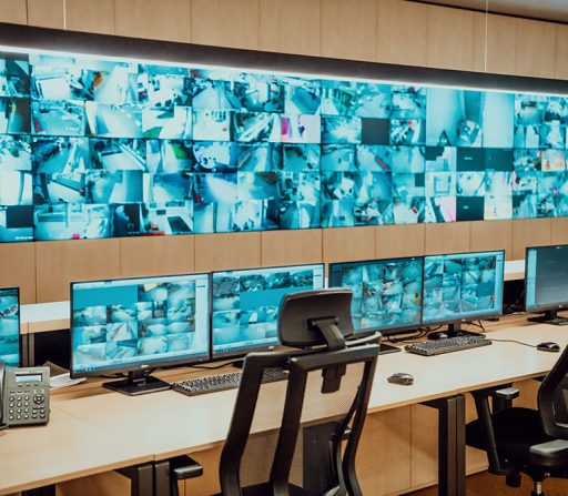 a security room with monitors and a phone