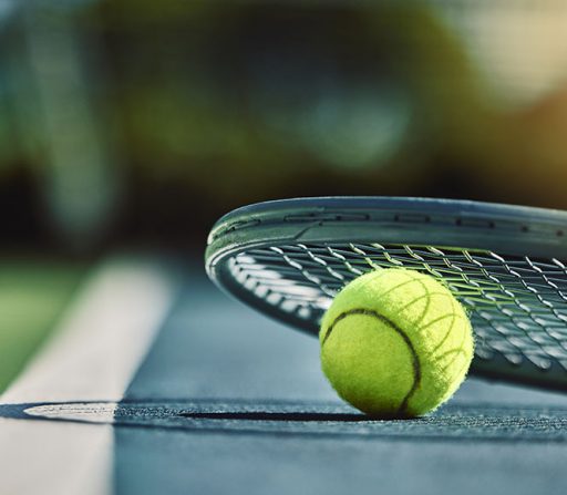 a tennis ball and racket on a tennis court