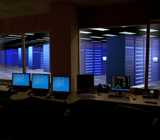 a row of computer monitors are sitting on a desk in a server room