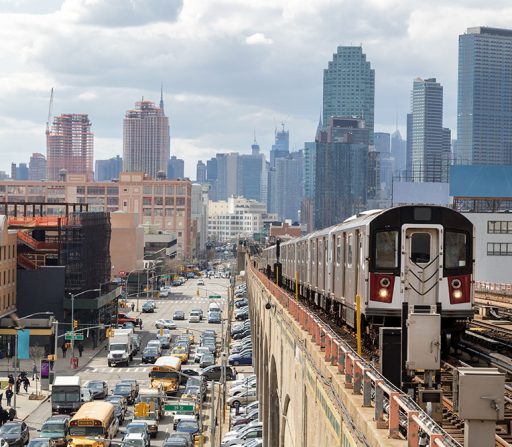 a subway train is going down the tracks in a city