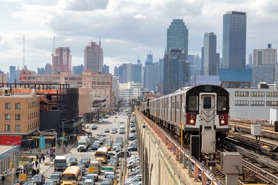 a subway train is going down the tracks in a city