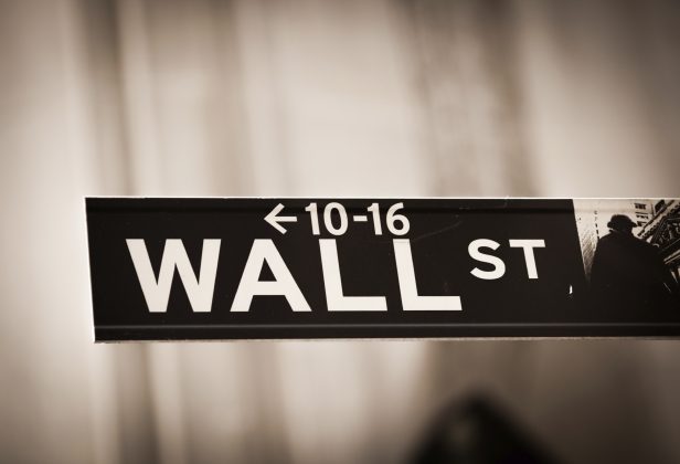 a black and white street sign for wall street