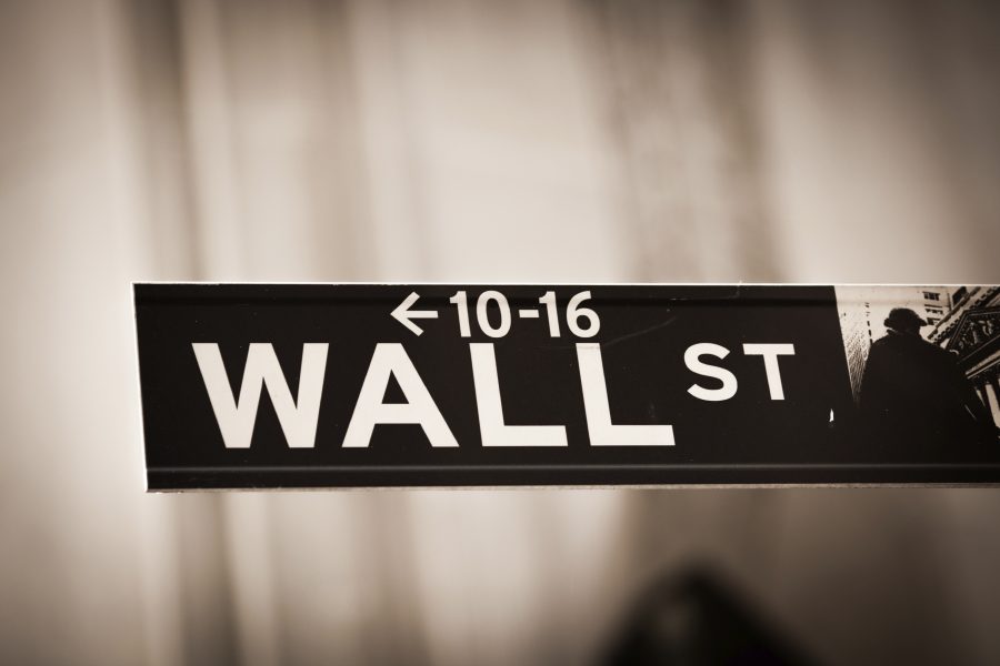 a black and white street sign for wall street