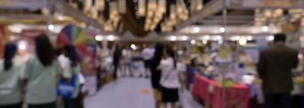 unfocused picture of people walking through a professional event