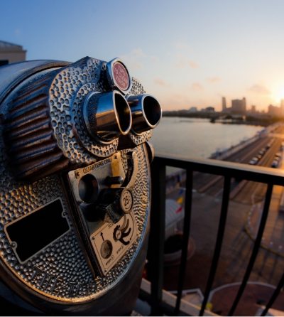 a coin operated binoculars looking out over a body of water